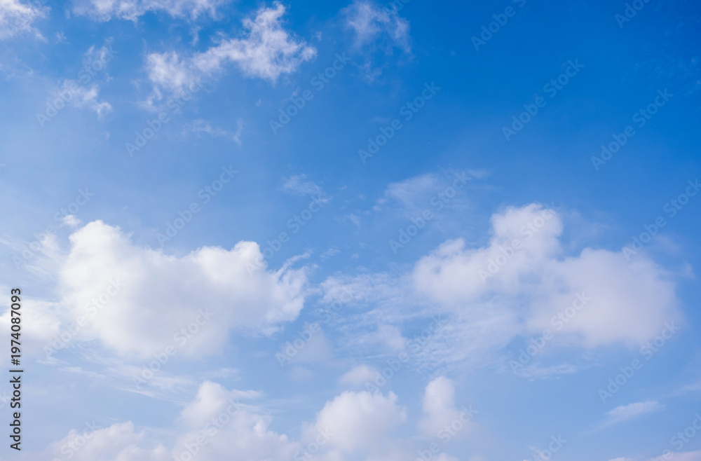 Obraz premium clear blue sky background,clouds with background, Blue sky background with tiny clouds. White fluffy clouds in the blue sky. 