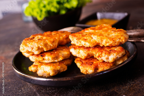fried chicken cutlets in dark bowl