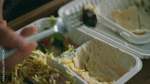 Takeaway meal in a white container - kebab with rice and salad