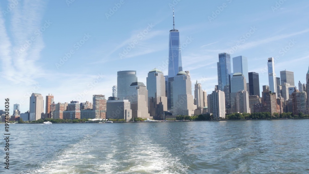 Fototapeta premium New York City Manhattan Downtown Financial District skyline, World Trade Center tower from ferry boat to New Jersey, United States of America. River waterfront urban cityscape with skyscraper building