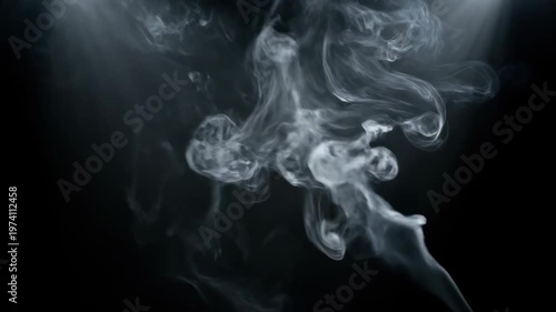 Wisps of white smoke gracefully dance and swirl against a dark, mysterious background, creating an ethereal and captivating visual effect.