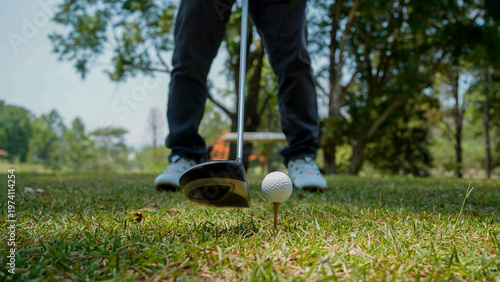 Golfer playing golf in the evening golf course, on sun set evening time.