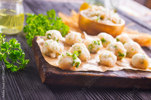 raw chicken balls on wooden board