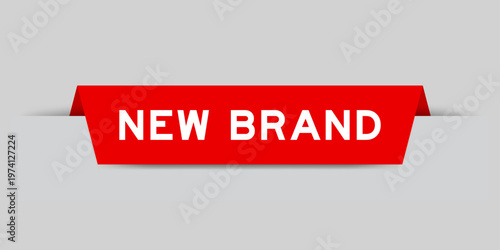 Red color inserted label with word new brand on gray background