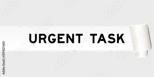 Ripped gray paper background that have word urgent task under torn part