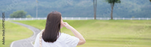 Relax and wellness concept with woman walk on road in garden and mountain background at chiangmai thailand in raining season