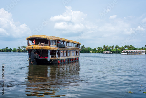 Traditional house boat and river view in Kerala's Backwaters, India.