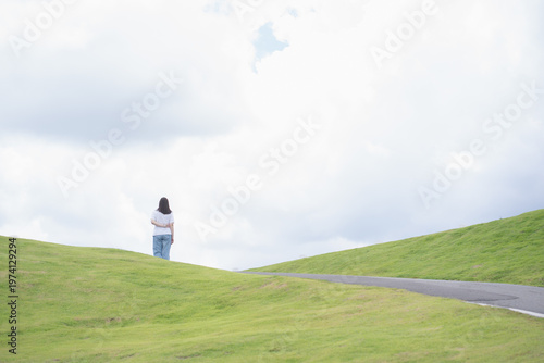 Relax and wellness concept with woman walk on road in garden and mountain background at chiangmai thailand in raining season