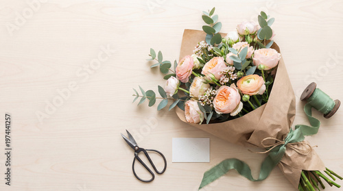 Beautiful bouquet of flowers lies on a beige background. Top view, copy space