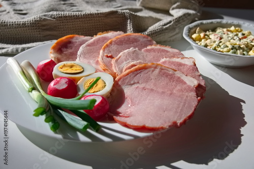 Closeup of processed meat, eggs, radish and spring onion on the table