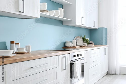 Modern kitchen with white cabinets and blue backsplash