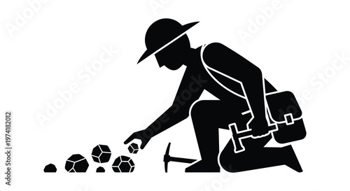 A miner examining rocks depicted in a striking black silhouette