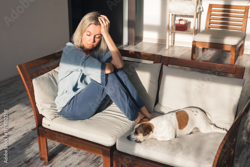 Depressed lonely unhappy mental woman sitting alone on the sofa feel stress