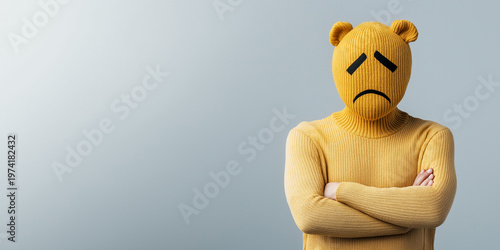 Person in a yellow sweater sports a bear head