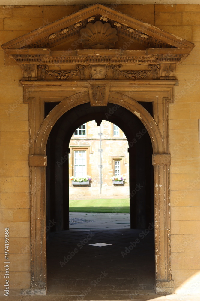 Fototapeta premium View through an archway into an Oxford college garden
