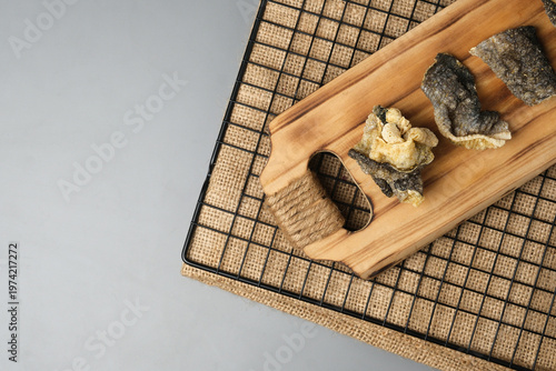 Crispy salmon skin snacks on a wooden board  burlap. Perfect for food blogs, restaurant menus, seafood advertisements, or culinary websites.
