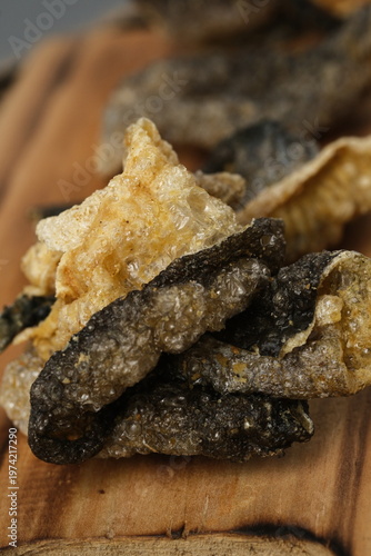 Crispy salmon skin snacks on a wooden board  burlap. Perfect for food blogs, restaurant menus, seafood advertisements, or culinary websites.