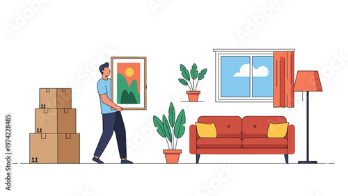 Young man carrying framed picture in new living room during house move surrounded by stacked cardboard boxes and furniture.