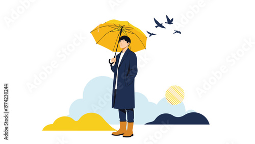 Stylish young man wearing a long dark coat and boots while holding a bright yellow umbrella on a cloudy and breezy day.