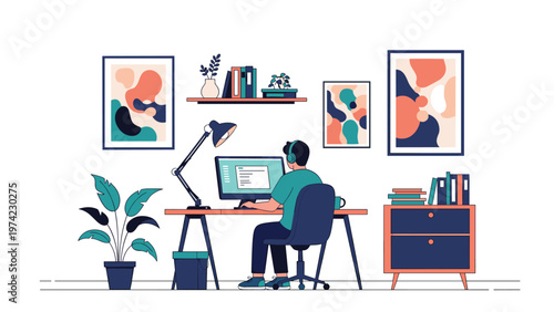 Focused professional man working on his desktop computer at a stylish and organized home office desk with art on the walls.