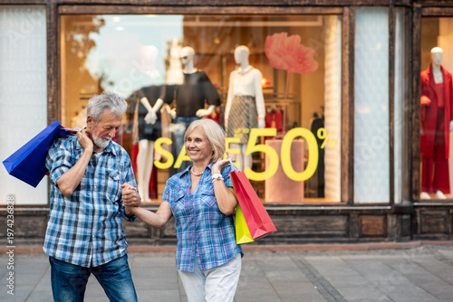 Happy senior couple with shopping bags