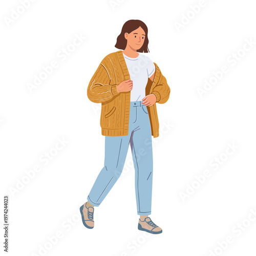 Woman wearing brown cardigan and blue jeans walks alone outside
