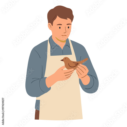 Man gently holds a small bird in his hands wearing an apron