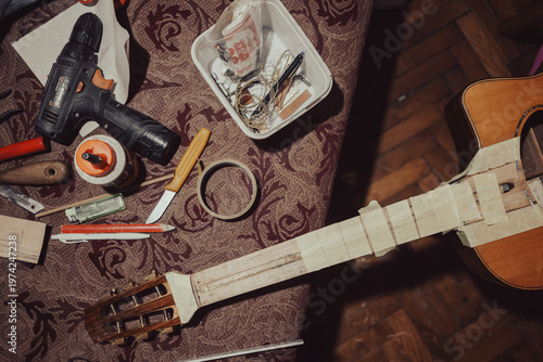 Acoustic guitar repair with tools around it