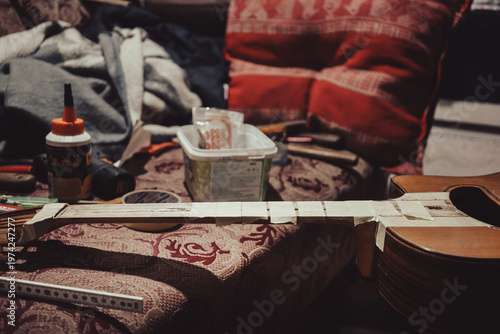 Acoustic guitar repair with tools around it
