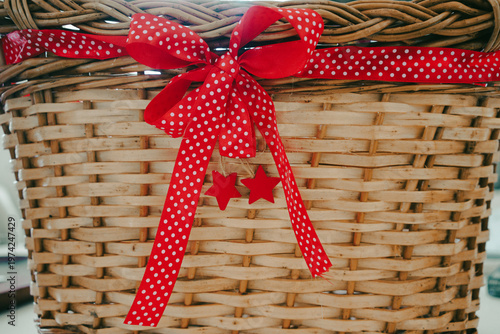 Red bow on a decorative wooden basket