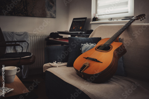 Gypsy jazz acoustic guitar on bed at home