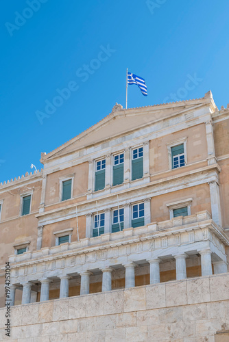 Greek flag flies over the Parliament building in Syntagma Square, Athens, Greece