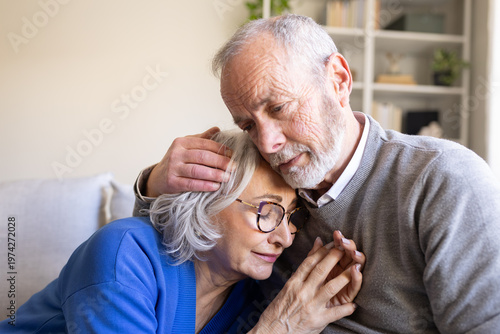 Bild auf Leinwand Senior man comforting sad wife at home suffering from alzheimer