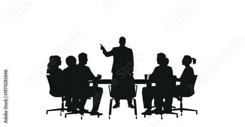A business leader stands to address a group of colleagues seated at a conference table during a crucial.