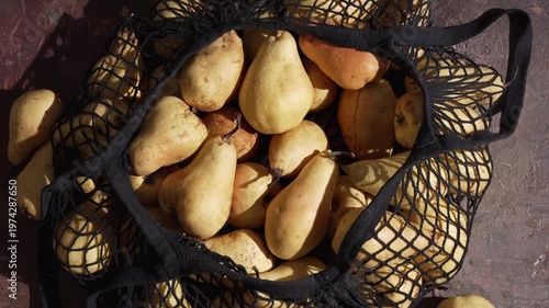 Reusable shopping string bag with pears. Zero-Waste Living, reducing disposable packaging and embracing reusable alternatives