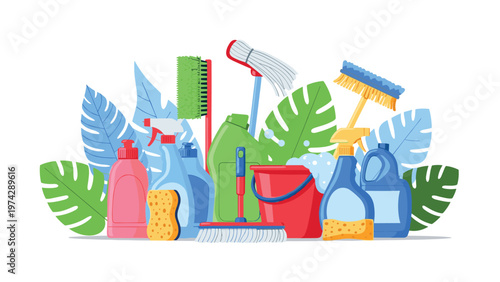 Large group of colorful household cleaning supplies such as spray bottles, sponges, brushes, and a bucket arranged with green leaves.