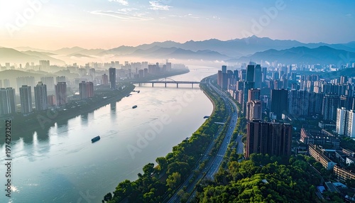 An aerial view showcases a sprawling cityscape nestled along a winding river, framed by majestic mountains bathed in the soft glow of dawn.
