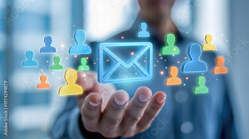 Hand holds glowing digital email envelope surrounded by user profile icons. Marketing campaign and mass communication network for audience outreach and subscriber database management