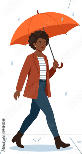 Woman walks down sidewalk with orange umbrella on rainy day