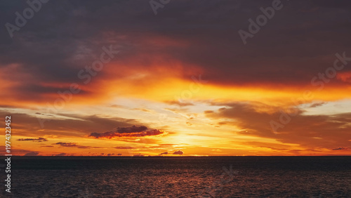 Sunset over sea with vibrant red and orange sky