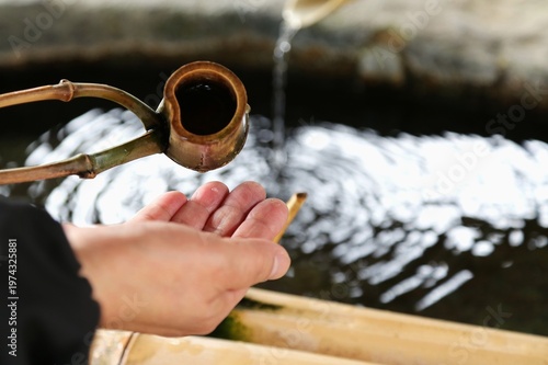 Japanese shrine purification ritual with water and ladle
