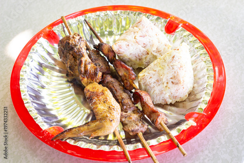 Filipino barbecue skewers made with grilled pork and chicken. typical Filipino food or picnic meal in the Philippines.