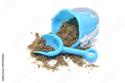 sand in blue plastic shovel and bucket isolated on white