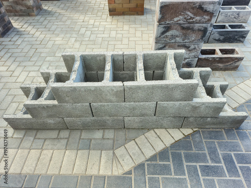 Stack of concrete blocks arranged in a tiered structure on a paved surface