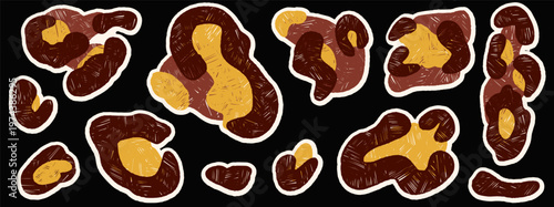 Paper cutout leopard spots on dark background with gold and brown. Bold paper cutout shapes with animal fur texture as vector set. Crayon skin elements for fashion scrapbook, print and collage design.