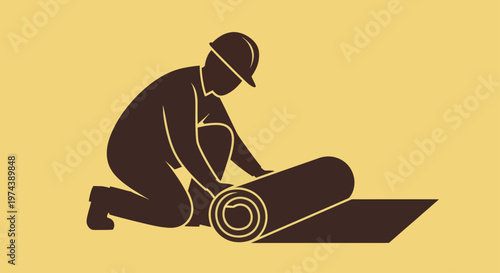 Worker installing flooring or carpet on a construction site.