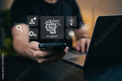 Person Using Smartphone to Interact with AI Agent Features and Technology Icons on Laptop Display in Modern Office Environment
