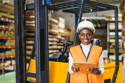 Bild auf Leinwand Female worker managing inventory in lumberyard warehouse