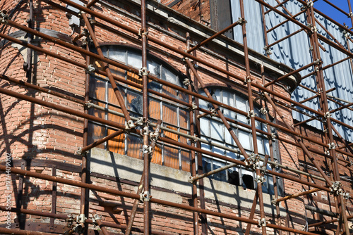 rusty scaffolding around an old, abandoned structure