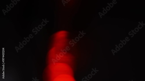 Colorful light reflections create patterns and shapes in the dark at nighttime event